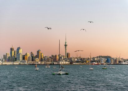 View of the Auckland cityscape across the water at sunset
