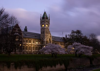 Classic Dunedin building at nighttime along the river