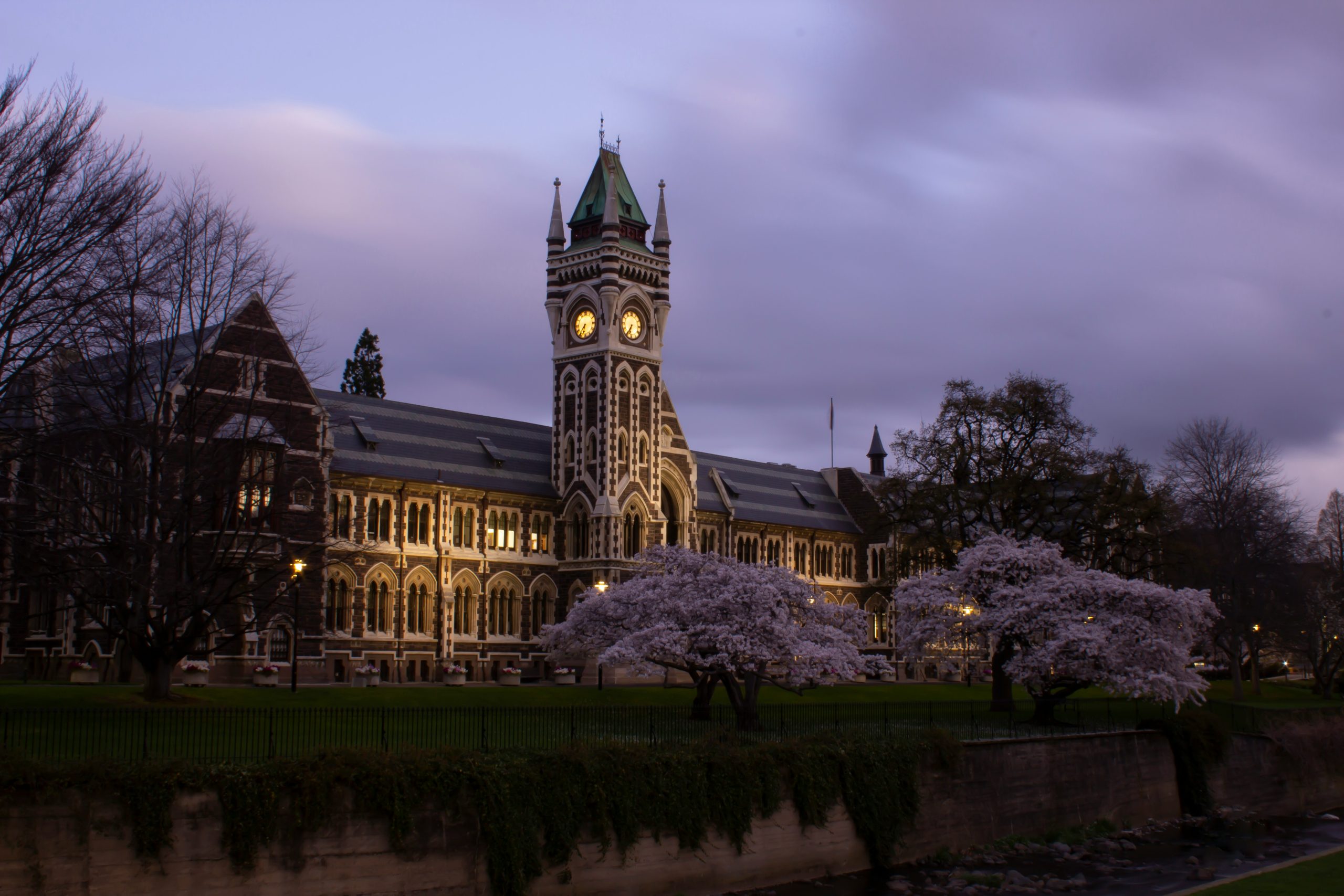 Classic Dunedin building at nighttime along the river
